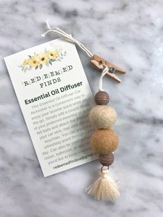 the essential oil diffuser is on top of a marble table with a note attached to it