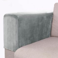 a gray couch sitting next to a white wall