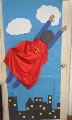 a door decorated to look like a superman with his cape flying through the air and clouds