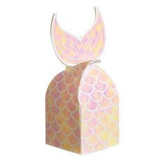 a paper box with an image of a mermaid tail on the top and bottom, sitting in front of a white background