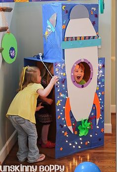 two children playing in a space themed room