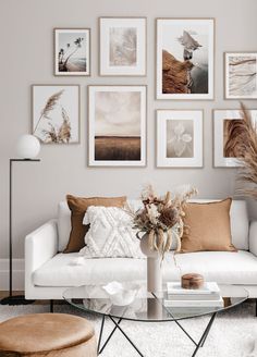 a living room filled with furniture and pictures on the wall above it's coffee table