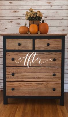 a wooden dresser with two pumpkins on top and the word after painted on it