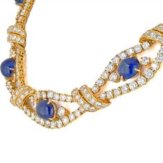 Featuring nine sapphire cabochons, accented by round diamonds. Sapphires measuring approximately 15.5 x 8.5 x 5.0 to 7.7 x 7.6 x 4.5 mm Diamonds weighing a total of approximately 32.00 to 36.00 carats Length 14 inches Signed M. Gerard, numbered 4487 French assay and workshop marks 18 karat goldCenter Diamond Weight: 40.00Metal Type: 18K Yellow GoldMetal Weight: 74.0 gr.Signed: M. GerardCondition: Excellent.Stock: RR9232 Yellow Rings, Yellow Jewelry, Vintage Engagement, Collar Necklace, Eternity Bands, Pearl Pendant, Ring Designs, Blue Sapphire, Round Cut