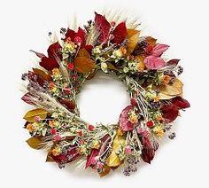 a wreath made out of dried flowers and leaves