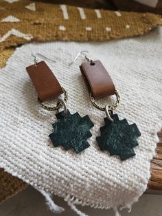 This particular pair of earrings is one of our favorites.  We combined a few of our favorite things...  Top tab is a gorgeous brown leather.  We used a few metal rings in both gold and silver.  Bottom piece is a Southwest inspired leather piece in a beautiful distressed deep teal.  These hang about 3 inches in length and are about 1 inch wide.  We only use genuine leather sourced from the USA.  Our earrings are incredibly lightweight and the ear wires are surgical stainless steel and nickel free Brown Brass Dangle Earrings, Artisan Leather Nickel-free Earrings, Everyday Hand Tooled Leather Jewelry, Everyday Hand-tooled Leather Jewelry, Unique Nickel-free Brown Jewelry, Nickel-free Brown Brass Earrings, Unique Brown Nickel-free Jewelry, Brown Artisan Metal Earrings, Artisan Brown Metal Earrings