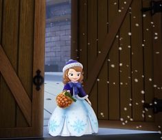 a doll is holding a pineapple in front of an open door with snow falling on it