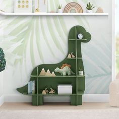 a child's room with green dinosaur bookshelves and wallpaper on the walls