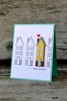 a card with a house on it and the words happy new home