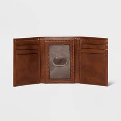 Comfortably carry your cards and money with this Trifold Wallet from Goodfellow & Co™. This tri-fold wallet features multiple card slots, ID pocket and a bill compartment, while the tri-fold design lends it a non-bulky feel, making it easier to slip in the front or rear pockets of your trousers. Best of all, it features RFID blocking that helps prevent your cards and IDs from digital theft. Showcasing a faux-leather finish in brown, it's sure to bring classic style to your everyday accessories. Affordable Brown Trifold Wallet For Daily Use, Trifold Wallet With Rfid Blocking For Travel, Travel Trifold Wallet With Id Window, Trifold Wallet With Id Window For Everyday Use, Trifold Wallet With Card Slots For Travel, Trifold Wallet With Card Slots, Travel Trifold Wallet With Card Slots, Brown Trifold Wallet For Travel, Brown Trifold Wallet For Daily Use