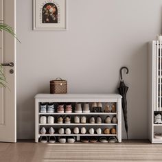 a white shelf filled with lots of shoes next to a door