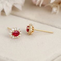 These 18K Yellow Gold Oval Ruby Stud Earrings with a Lab Diamond Halo are the perfect addition to any jewelry collection. Luxury Oval Ruby Earrings, Luxury 14k Gold Oval Earrings, Yellow Gold Oval Halo Earrings, Elegant Oval Halo Earrings, Elegant Ruby Earrings With Halo Setting, Yellow Gold Oval Diamond Earrings With Gemstone, Elegant Oval Cluster Earrings In Yellow Gold, Elegant Gold Cluster Halo Earrings, Luxury Oval Diamond Earrings For Gift