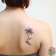 a woman with a palm tree tattoo on her back