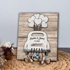 a wedding card with an image of a car and balloons in the back, on top of a basket