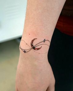 a woman's wrist with a tattoo on it that has an arrow in the middle