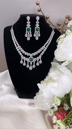 "Decked up in drama and a lot of shimmer! This luxurious ensemble is encrusted with CZ / American Diamonds in invisible & prong setting along with Emerald Green faux stone. Beautiful Statement Earrings are included, can be styled without the necklace too. The necklace is adjustable with matching specialty chain. This necklace is full of lusture and looks very elegant. Style this perfect versatile cocktail necklace set with any Indian / Indo Western Attire.   WHAT GOES IN  👉🏻American Diamond / Dazzling Hand-set Emerald Necklace, Green Hand-set Cubic Zirconia Bridal Necklace, Luxury Emerald-cut Emerald Necklace For Formal Occasions, Luxury Multi-stone Emerald Necklace For Formal Occasions, Exquisite Hand-set Green Emerald Necklace, Cocktail Necklace, Double Layer Necklace, Cocktail Jewelry, Diamond Necklace Set