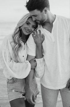 a man and woman standing next to each other in front of the ocean with text that reads send message