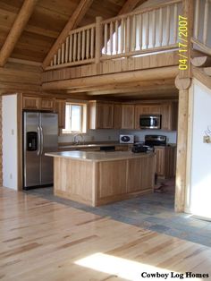 a kitchen with wooden cabinets and stainless steel appliances in the middle of an open floor plan