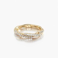 a yellow gold ring with three rows of diamonds on the inside and outside of it