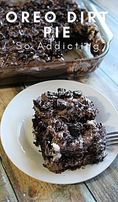 a piece of oreo dirt pie on a plate with a fork next to it