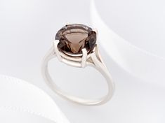 "Grade AAA, Fine Quality, Natural, large Smoky Quartz Solitaire Ring in premium silver ring setting. Beautiful color: medium to dark rich brown. Strong tone, and superior clarity (IF). These gemstones were cut to our specifications by a lapidary expert. The cut is Concave and nearly perfect. Material: 925 Premium Sterling Silver, U.S. Sizes: 5 - 10 ( 1/2 Increments) We used De-Ox silver for the heavy band and tray, which is cast in an oxygen-free environment - more shine, less tarnish. Primary G Modern Brown Rings For Anniversary, Modern Brown Anniversary Ring, Elegant Smoky Quartz Brown Rings, Brown Round Rings For Anniversary, Elegant Brown Round Rings, Smoky Quartz Brown Rings For Gifts, Brown Smoky Quartz Rings For Gift, Brown Smoky Quartz Rings For Gifts, Elegant Smoky Quartz Rings For Anniversary