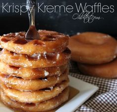 a stack of doughnuts on a plate with a fork stuck in the middle