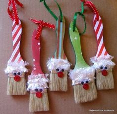 christmas decorations made out of brooms with santa's hats and noses on them