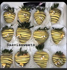 chocolate covered strawberries with yellow stripes and green leaves