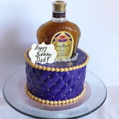 a birthday cake with a bottle of liquor on top