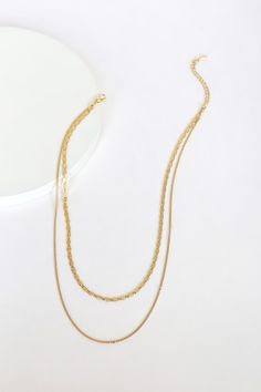 Sometimes most minimal pieces make the biggest impact! The Lulus Simple Elegance Gold Layered Necklace is ultra-trendy with its mariner-link chain and plain gold chain that layer together beautifully. Lobster clasp closure. Shortest necklace measures 14" long with a 2. 5" extender chain. Man made materials. Imported. Lulus | Simple Elegance Gold Layered Necklace. Gold Layered Chain Link Necklace, Minimalist Gold Layered Necklace With Figaro Chain, Gold Delicate Chain Link Layered Necklace, Gold Double Strand Figaro Chain Necklace, Gold Double Strand Layered Necklace With Chunky Chain, Minimalist Gold Metal Layered Necklace, Trendy Gold Layered Necklace With Figaro Chain, Minimalist Layered Gold Chain Necklace, Minimalist Multi-strand Gold Chain Layered Necklace