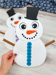 two snowmen made out of construction paper