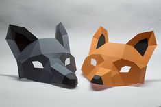 two origami fox masks sitting next to each other