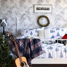 a bed room with a guitar and a christmas tree