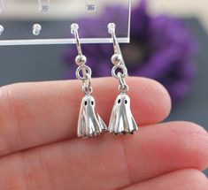 Cute and Dainty Ghost Earrings.  Introducing our stunning Sterling Silver Ghost Earrings! These hauntingly beautiful ghost earrings are the perfect blend of spooky and stylish.  Made from high-quality .925 sterling silver, these earrings are both durable and hypoallergenic, making them perfect for sensitive ears. Their unique silvery sheen adds a touch of elegance to any outfit, while the playful ghost shape adds a fun and quirky element.  Whether you're looking to make a statement on Halloween Gift Dangle Earrings, Spooky Silver Pierced Earrings, Spooky Nickel-free Silver Earrings, Spooky Silver Nickel-free Earrings, Gothic Halloween Earrings Gift, Spooky Nickel-free Jewelry For Party, Spooky Nickel-free Party Jewelry, Halloween Plug Earrings As Gift, Dangle Halloween Earrings