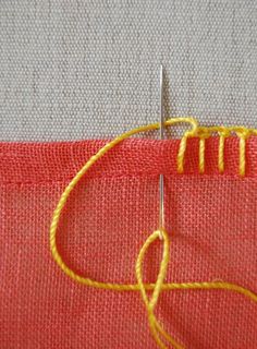 a close up of a piece of cloth with yellow thread