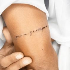 a woman's arm with the word para sempre written on it in cursive font