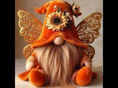 an orange fairy doll sitting on top of a table