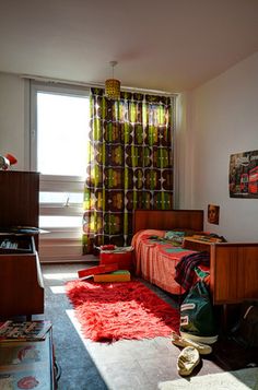 a bedroom with a bed, dresser and window