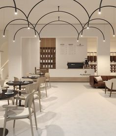 the interior of a restaurant with tables and chairs in white, wood and black colors