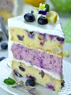 a slice of cake with blueberries and lemon on top