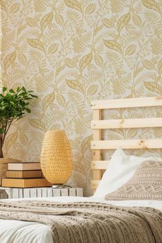 a bed sitting next to a potted plant on top of a wooden headboard