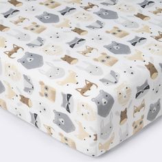 an image of a baby crib sheet that has animals on it in grey and beige colors