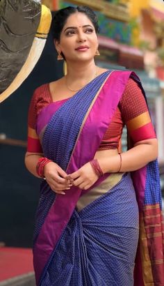 a woman in a blue and pink sari