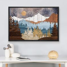 a painting hanging on the wall above a table