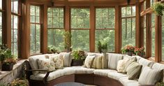 a sun room filled with lots of windows and furniture