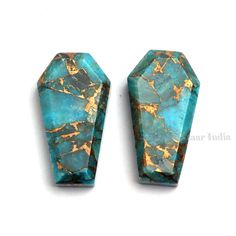 two blue and gold colored stones sitting on top of each other