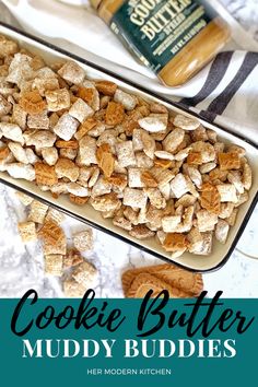 cookie butter muddy buddies in a baking pan with peanut butter on top and the words, cookies butter muddy buddies