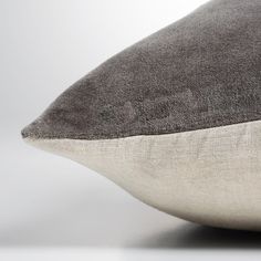 a gray and white pillow sitting on top of a table