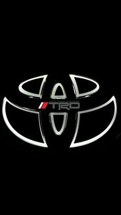 the front end of a toyota logo on a black background with red and white stripes