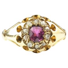 A classic and timeless antique cluster ring is a perfect gifting or engagement ring choice. This gorgeous Edwardian era cluster ring is one of those elegant beauties, it features a lovely pinky red ruby which is surrounded by a halo of rose cut diamonds. All set into rich 18ct yellow gold with chunky shoulders and a slender tapering gold band and a belcher style setting. Looks great stacked with a nice gold band or worn alone. Marks and era: Edwardian era, fully hallmarked for 18ct gold, Birmingham assay office, Date letter rubbed c1900s. Condition: Good used condition overall, minor surface wear, commensurate with age, some light surface wear to the stone, thinning to the back of the band from wear. Ring face Approx 8.9mm length and 1.5mm band width. Central Ruby approx 0.30ct weight, est Classic Pink Cluster Ring For Formal Occasions, Classic Pink Cluster Ring With Center Stone, Classic Ruby Ring With Rose Cut Diamond Cluster, Vintage Ruby Cluster Ring With Center Stone, Vintage Ruby Ring With Halo Setting, Antique Style Gemstone Cluster Promise Ring, Antique Gemstone Cluster Ring For Promise, Elegant Pink Cluster Ring With Rose Cut Diamonds, Elegant Pink Rose Cut Diamond Cluster Ring